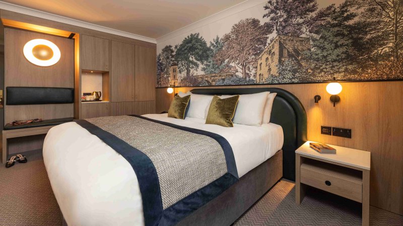 Signature bedroom at the Menlo Park Hotel with king bed and feature wall mural